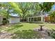 Backyard with a well-maintained lawn, shade trees, and a detached garage, creating a serene outdoor space at 112 Roselle Ave, Goose Creek, SC 29445