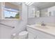 Well-lit bathroom featuring a window with shutters, white vanity and accessibility bar at 112 Roselle Ave, Goose Creek, SC 29445