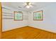 Bedroom features hardwood floors, shelving, ceiling fan, and large windows with wood trim at 112 Roselle Ave, Goose Creek, SC 29445
