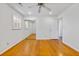 Well-lit bedroom with hardwood floors, ceiling fan, window and closet with mirrored sliding doors at 112 Roselle Ave, Goose Creek, SC 29445