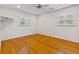 Bright bedroom with hardwood floors, ceiling fan, and windows with shutters at 112 Roselle Ave, Goose Creek, SC 29445
