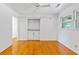 Bright bedroom with hardwood floors, built-in shelving, and a sunny window at 112 Roselle Ave, Goose Creek, SC 29445