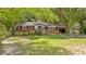 Inviting single-story brick home with a well-manicured lawn and mature trees at 112 Roselle Ave, Goose Creek, SC 29445