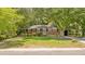 Classic brick home showcasing mature landscaping, a ramp, and attached garage, blending accessibility with curb appeal at 112 Roselle Ave, Goose Creek, SC 29445
