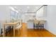 Eat-in kitchen features wood floors, a peninsula with bar stools and white cabinetry at 112 Roselle Ave, Goose Creek, SC 29445