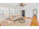 Cozy living room with hardwood floors, shutters, and neutral colored furnishings at 112 Roselle Ave, Goose Creek, SC 29445