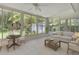 Comfortable sunroom filled with natural light, showcasing a seating area, game table, and views of the lush outdoors at 112 Roselle Ave, Goose Creek, SC 29445