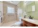 A bathroom features a tiled walk-in shower and a granite vanity with a cherry finish at 113 Jackson Rd, Ladson, SC 29456