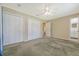 A carpeted bedroom features two large closets, a ceiling fan, and neutral paint colors at 113 Jackson Rd, Ladson, SC 29456