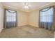 A bright carpeted bedroom features two windows with drapes and neutral paint at 113 Jackson Rd, Ladson, SC 29456