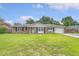 Charming brick home with a well-maintained lawn, black shutters, and a covered parking area at 113 Jackson Rd, Ladson, SC 29456