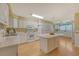 Open kitchen featuring an island, white cabinetry, and modern appliances at 113 Jackson Rd, Ladson, SC 29456
