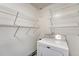 A laundry room is outfitted with wire shelving and a modern washing machine at 113 Jackson Rd, Ladson, SC 29456