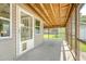 Covered sunroom featuring a wooden ceiling and pet door for access to the backyard at 113 Jackson Rd, Ladson, SC 29456