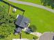 Aerial view of a property showcasing a well-manicured lawn, patio, and mature trees at 1213 Grasswind Dr, Hanahan, SC 29410