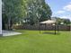 Expansive backyard with a well-maintained lawn, privacy fence, and charming gazebo at 1213 Grasswind Dr, Hanahan, SC 29410