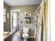 Clean bathroom with a toilet, shower with curtain, and an doorway to another room at 1213 Grasswind Dr, Hanahan, SC 29410
