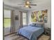 Comfortable bedroom with natural light, hardwood floors, and unique modern decorations at 1213 Grasswind Dr, Hanahan, SC 29410