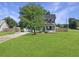 Charming two-story home with a spacious front yard and mature shade tree at 1213 Grasswind Dr, Hanahan, SC 29410