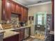 Well-lit kitchen featuring stainless steel appliances, granite countertops, and beautiful wooden cabinets at 1213 Grasswind Dr, Hanahan, SC 29410