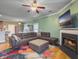 Bright living room with an open floor plan, fireplace, and view into dining area at 1213 Grasswind Dr, Hanahan, SC 29410