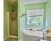Serene main bathroom with a soaking tub, separate shower, and a bright window at 1213 Grasswind Dr, Hanahan, SC 29410