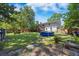 Spacious backyard featuring a lawn, trees, playset, and above-ground pool, perfect for outdoor activities at 124 Englewood Rd, Goose Creek, SC 29445