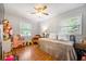Bright bedroom with hardwood floors, two windows and a day bed topped with many pillows at 124 Englewood Rd, Goose Creek, SC 29445