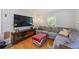 Comfortable living room with hardwood floors, gray sofa, large TV, and a cozy atmosphere at 124 Englewood Rd, Goose Creek, SC 29445