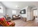 Cozy living room with a large screen TV, comfortable seating, and wood laminate flooring at 124 Englewood Rd, Goose Creek, SC 29445