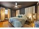 Stylish main bedroom with dark walls, modern ceiling fan, plush bedding, and ambient lighting at 124 Englewood Rd, Goose Creek, SC 29445