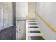 Interior stairway featuring neutral colors, carpeted steps, and a wooden handrail, creating a seamless transition at 124 Englewood Rd, Goose Creek, SC 29445