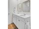 Bright bathroom featuring double sinks with white cabinets, gold hardware, and gold framed mirrors at 138 Sweet Cherry Ln, Summerville, SC 29486