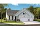 Charming single-story home with light green siding, stone accents, well-manicured lawn and two car garage at 1730 Locals St, Summerville, SC 29485