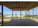 Framed view of the ocean and beach from an exposed room with new floor in a home under construction at 2879 Marshall Blvd, Sullivans Island, SC 29482
