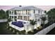 Beautiful two-story home exterior showcases a private pool, balconies, and lush landscaping at 2879 Marshall Blvd, Sullivans Island, SC 29482