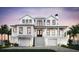 Stunning two-story home exterior with double garages, a grand staircase, and covered front porch at 2879 Marshall Blvd, Sullivans Island, SC 29482