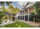 Backyard featuring a pergola and a firepit area with chairs, exterior stairs and a screened in porch at 2911 Old Tavern Ct, Mount Pleasant, SC 29466