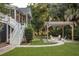 Backyard featuring a pergola and a firepit area with chairs, exterior stairs and a screened in porch at 2911 Old Tavern Ct, Mount Pleasant, SC 29466