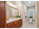 Bathroom with brown wooden cabinets, granite counters, a toilet and tiled floors at 2911 Old Tavern Ct, Mount Pleasant, SC 29466