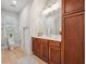 Bathroom with cherry cabinets, granite counters, large mirror, a toilet and tiled floors at 2911 Old Tavern Ct, Mount Pleasant, SC 29466