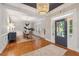 Elegant dining room featuring hardwood floors, a stylish chandelier, and a view of the front porch at 2911 Old Tavern Ct, Mount Pleasant, SC 29466