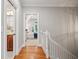 Hallway with hardwood floors connecting to a bathroom and bedroom, creating a seamless flow at 2911 Old Tavern Ct, Mount Pleasant, SC 29466