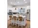 Kitchen features white cabinets, eat-in island, stainless steel appliances, and stylish light fixtures at 2911 Old Tavern Ct, Mount Pleasant, SC 29466