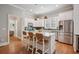 Kitchen with white cabinets, stainless appliances, eat-in island, and hardwood flooring at 2911 Old Tavern Ct, Mount Pleasant, SC 29466