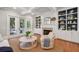 Inviting living room with built-in shelving, a cozy fireplace, and glass doors opening to an outdoor space at 2911 Old Tavern Ct, Mount Pleasant, SC 29466