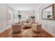 Cozy living room featuring hardwood floors, plantation shutters, stylish furniture, and a decorative mirror for added charm at 2911 Old Tavern Ct, Mount Pleasant, SC 29466