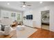 Cozy living room features hardwood floors, shiplap accent wall, and a view into an adjacent bedroom at 2911 Old Tavern Ct, Mount Pleasant, SC 29466