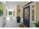 Charming porch with rocking chairs, a blue front door, and decorative plants creating a cozy and inviting entrance at 2911 Old Tavern Ct, Mount Pleasant, SC 29466