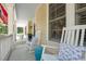 Inviting porch featuring comfortable white rocking chairs, blue decorative accents, and a view of the outdoors at 2911 Old Tavern Ct, Mount Pleasant, SC 29466